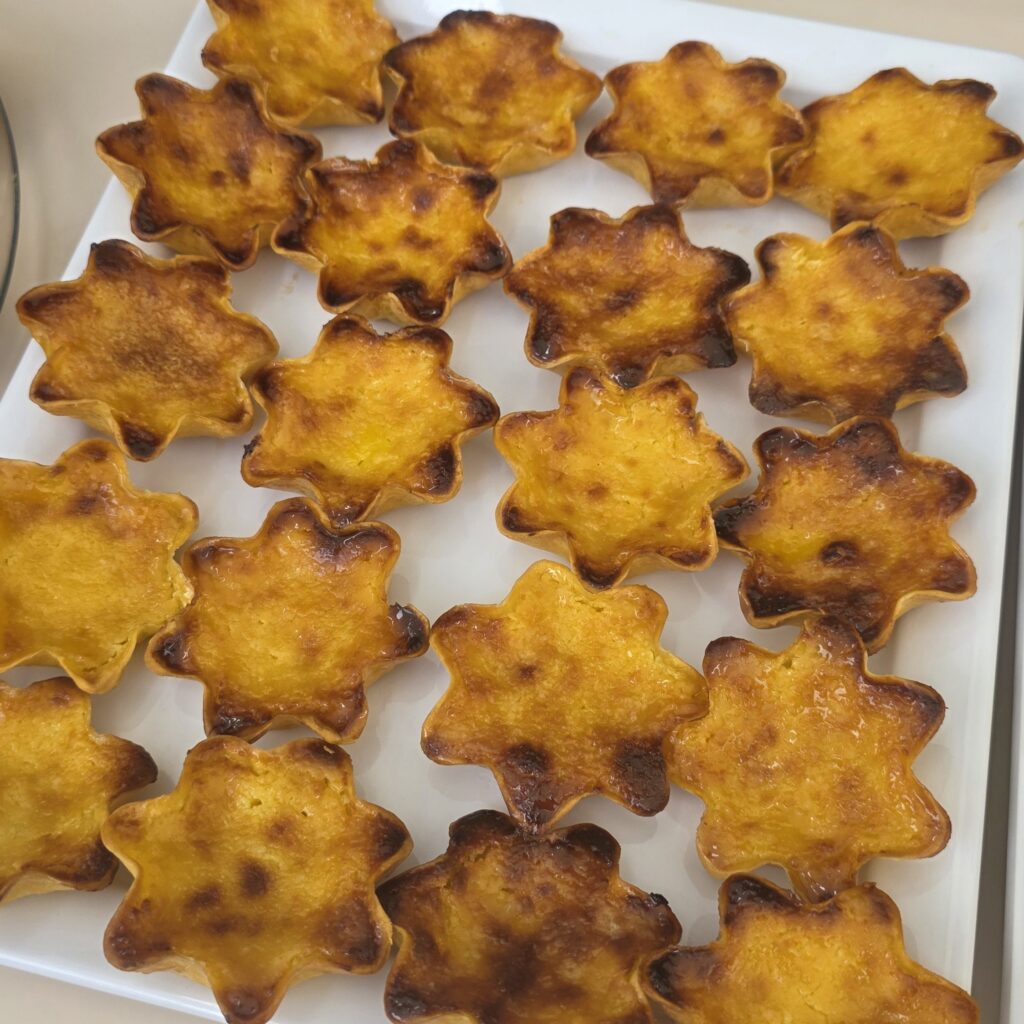 Star shaped pastéis de nata on a white plate.